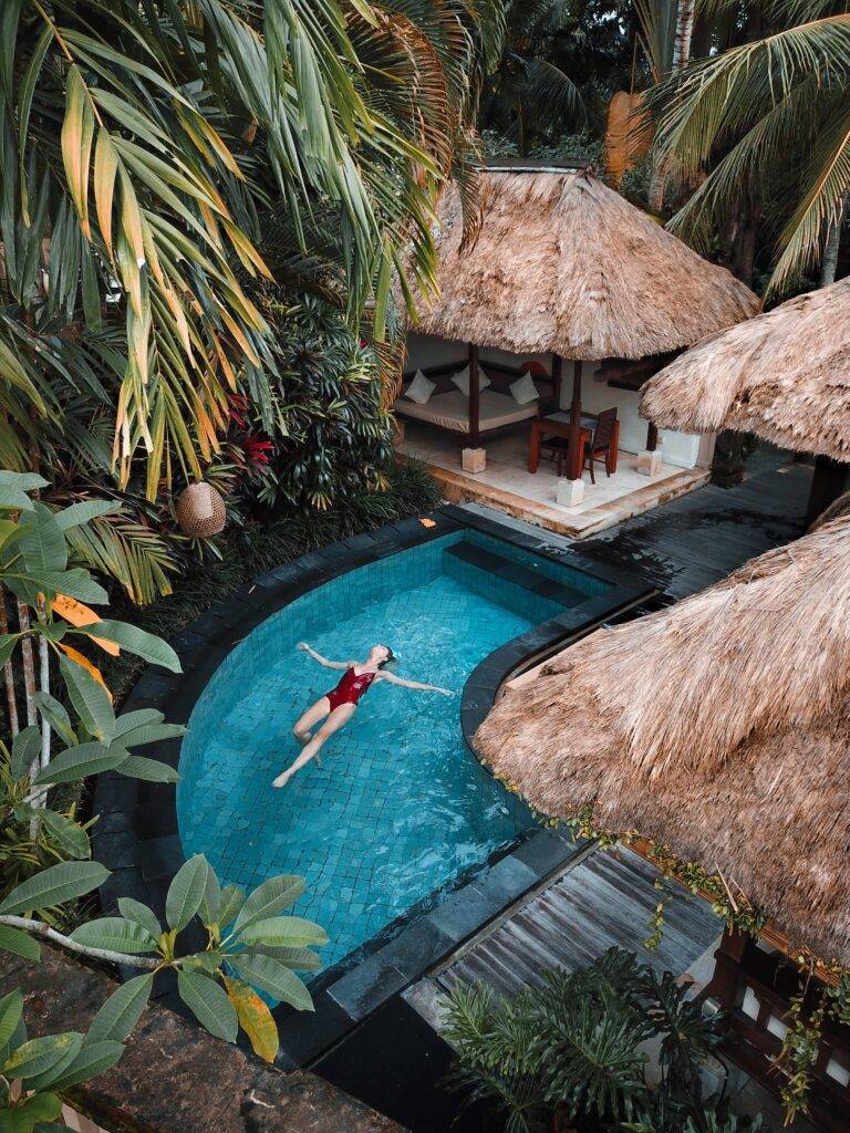 A women floats in a tranquil pool enjoying Bali future.