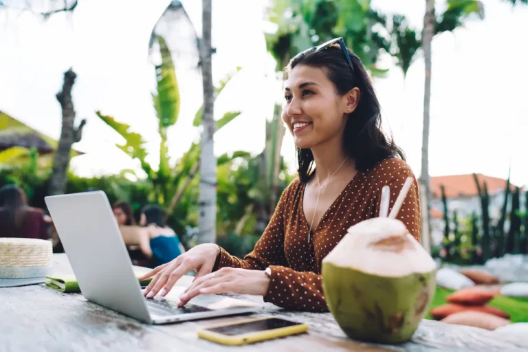 cheerful-asian-woman-browsing-laptop-2023-11-27-05-36-40-utc