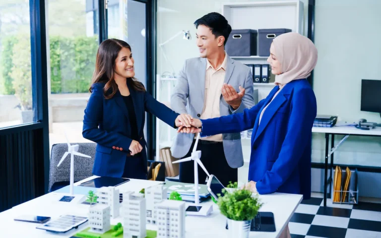 three-business-people-gather-at-a-desk-unit-with-2024-05-10-23-30-29-utc